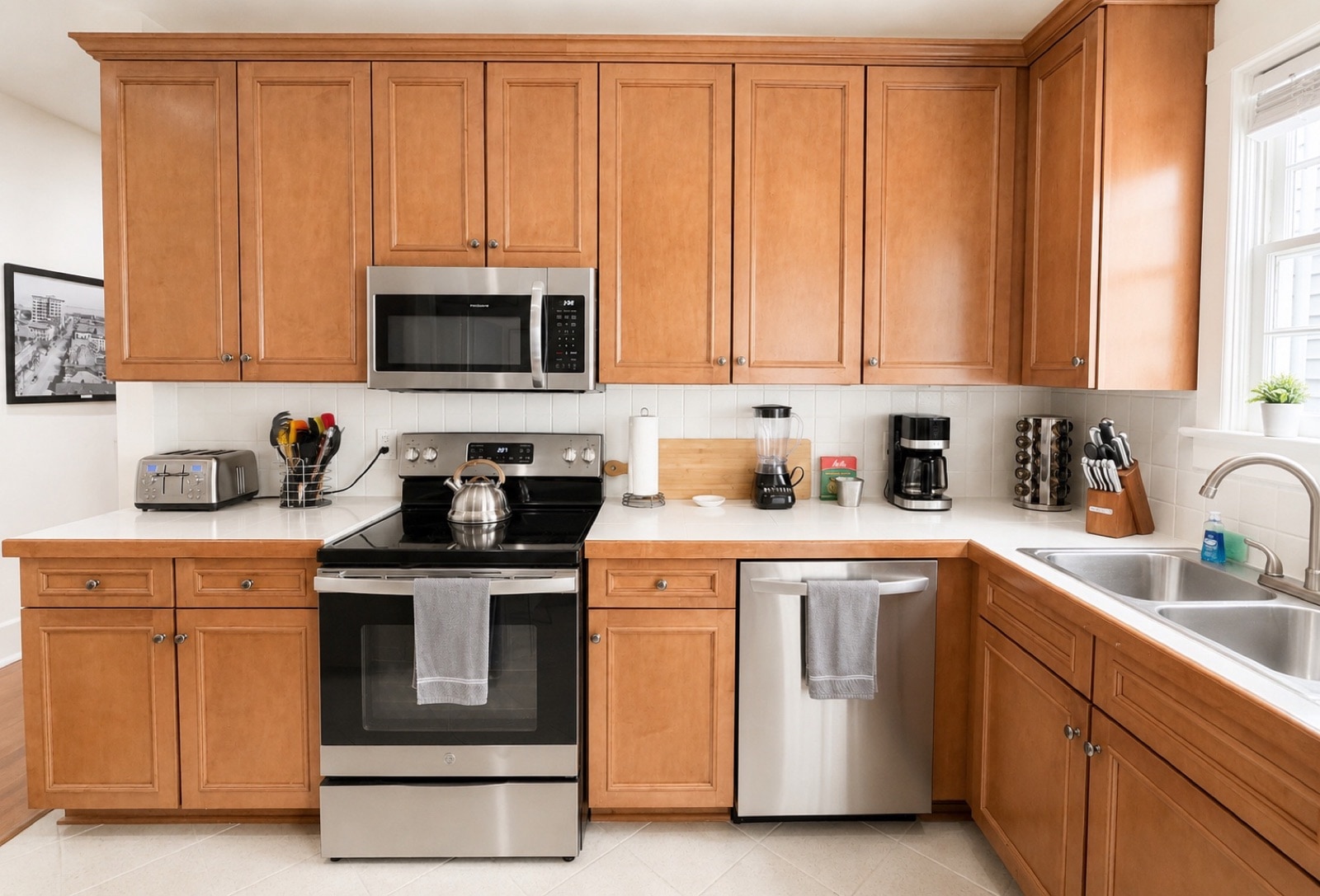 Full kitchen - wood cabinets, stainless stove, microwave, dishwasher, coffee station by the window