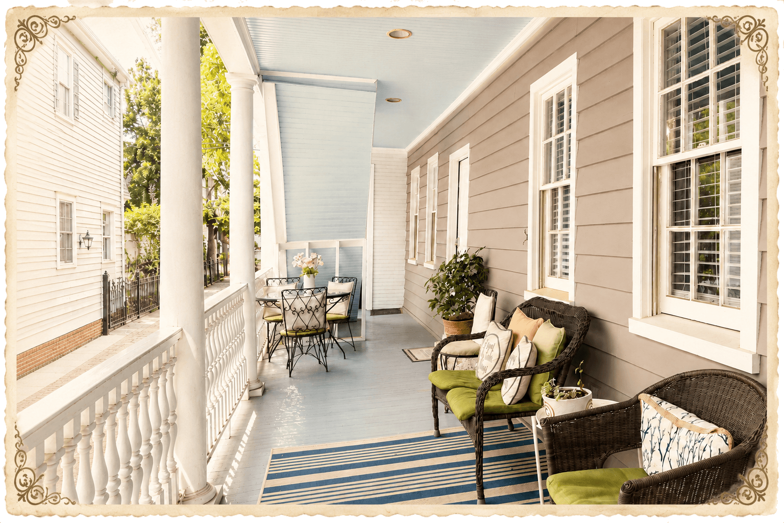 The haint-blue piazza of The Fig House on Spring, in a vintage scalloped frame