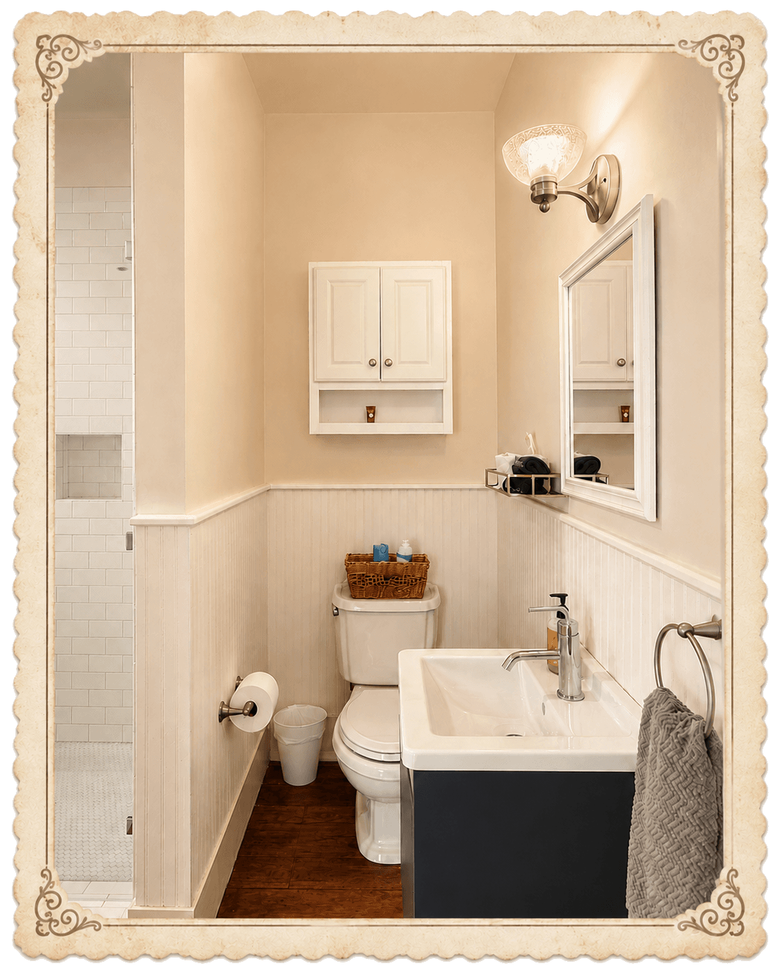 Bathroom with white tile shower opening, navy vanity, bright mirror, and white wainscot
